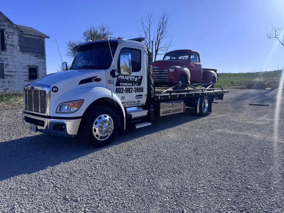 Vintage dark pickup truck loaded on for transport
