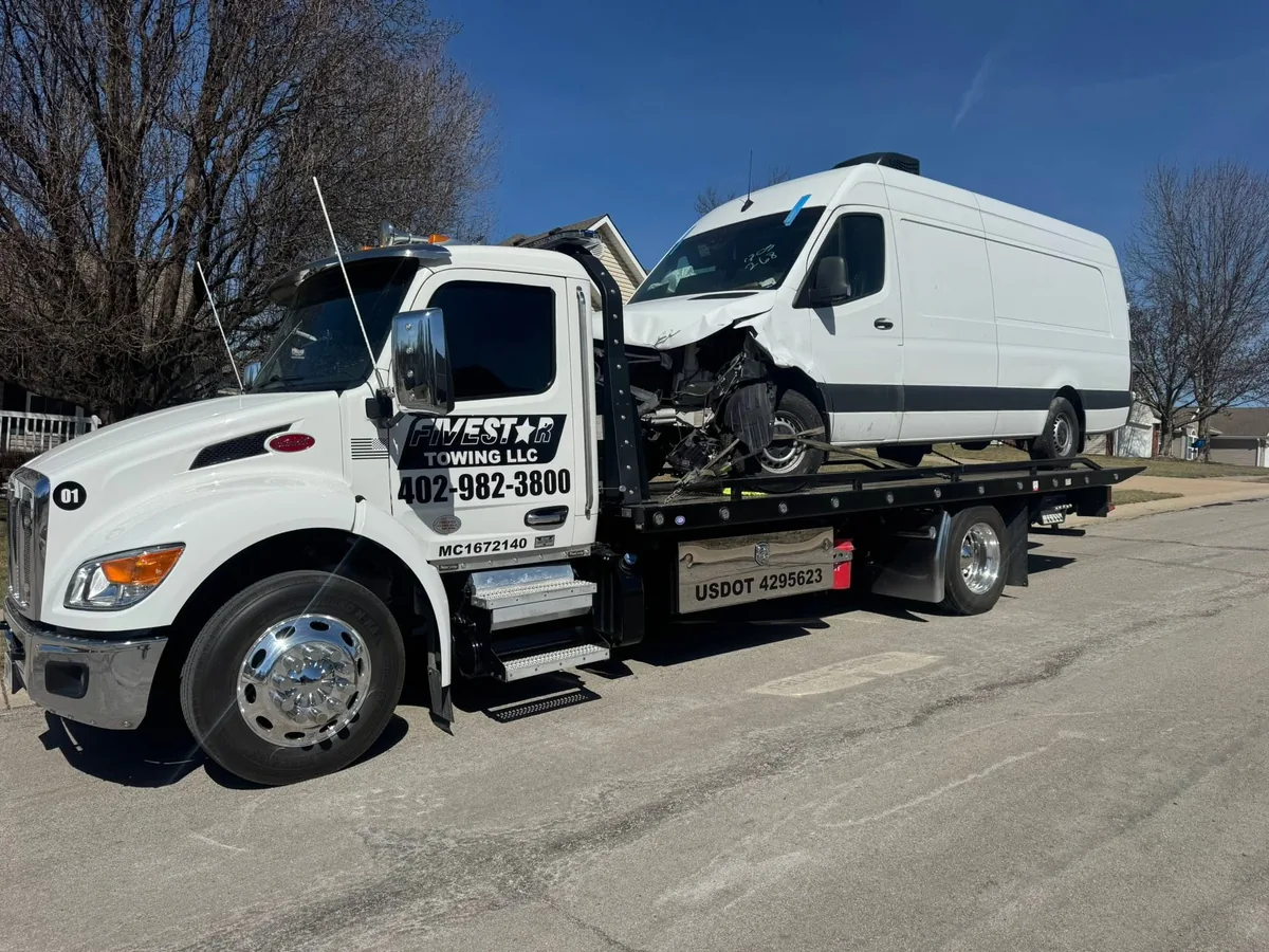Wrecked white high roof cargo van with front end damage