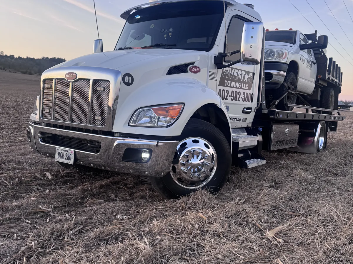 Tow truck recovering a vehicle from a muddy field