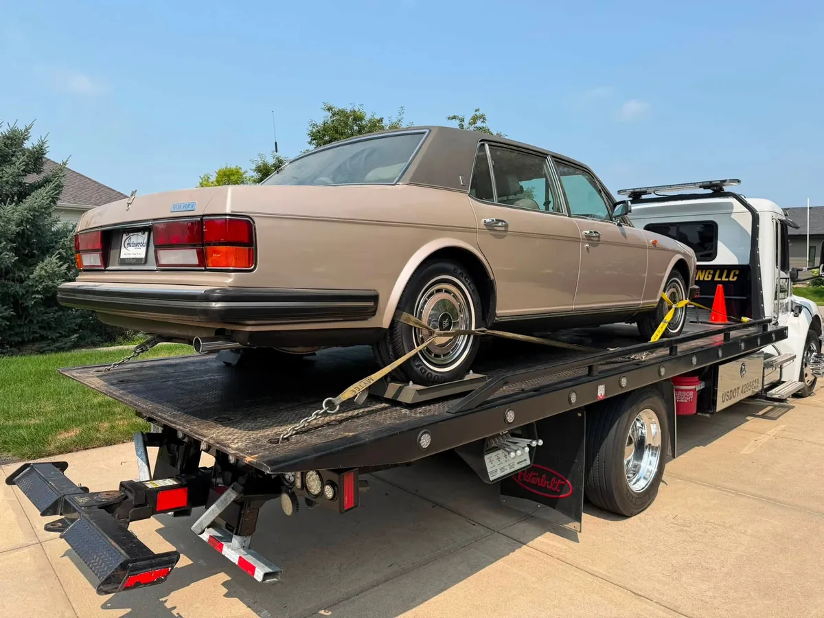 Classic tan luxury sedan strapped down