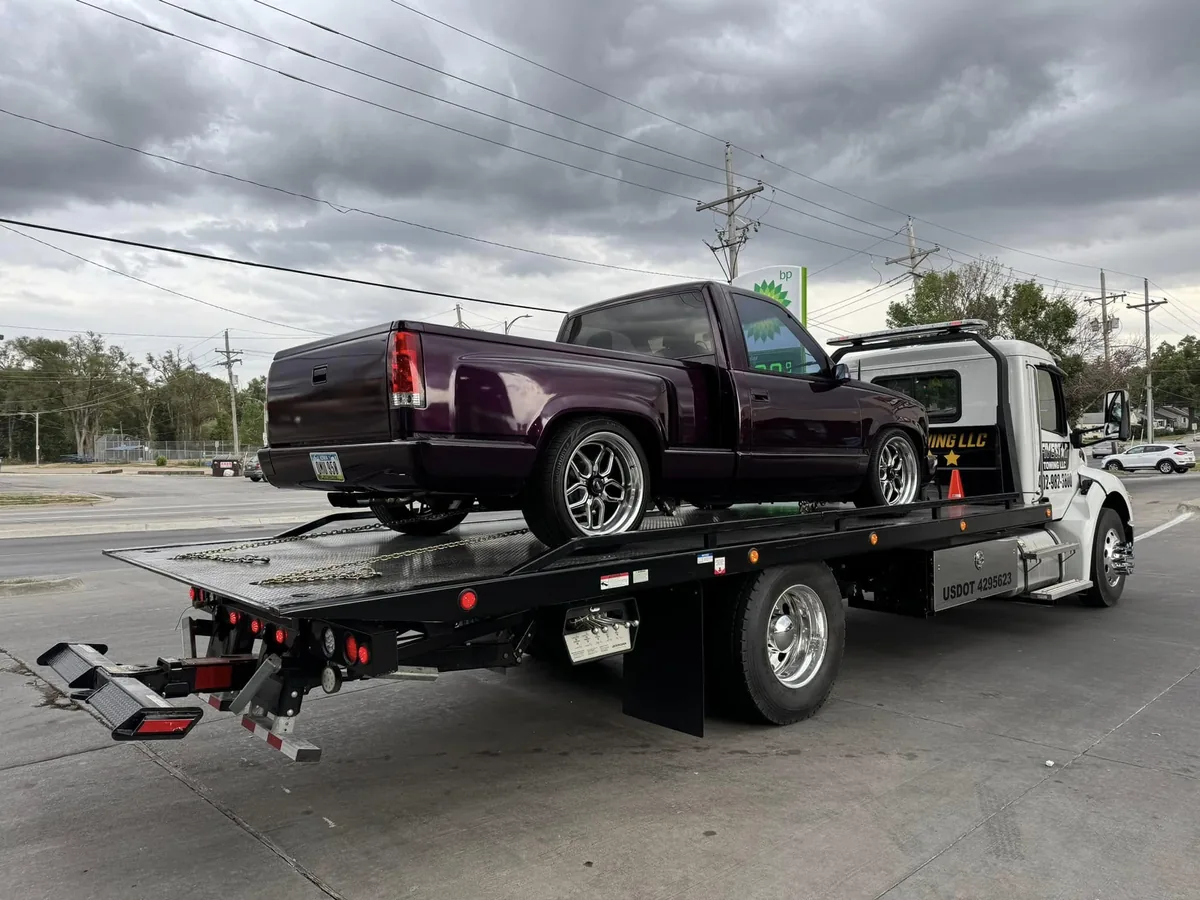 Lowered custom maroon pickup truck strapped